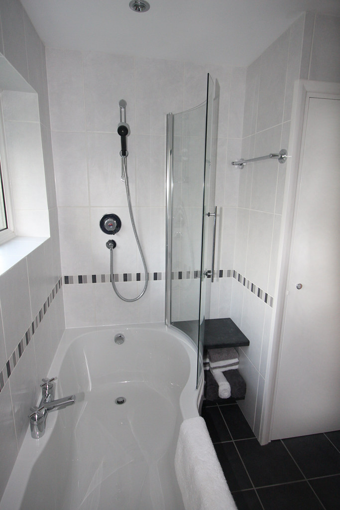 Compact shower room refit with curved glass screen and new tiling